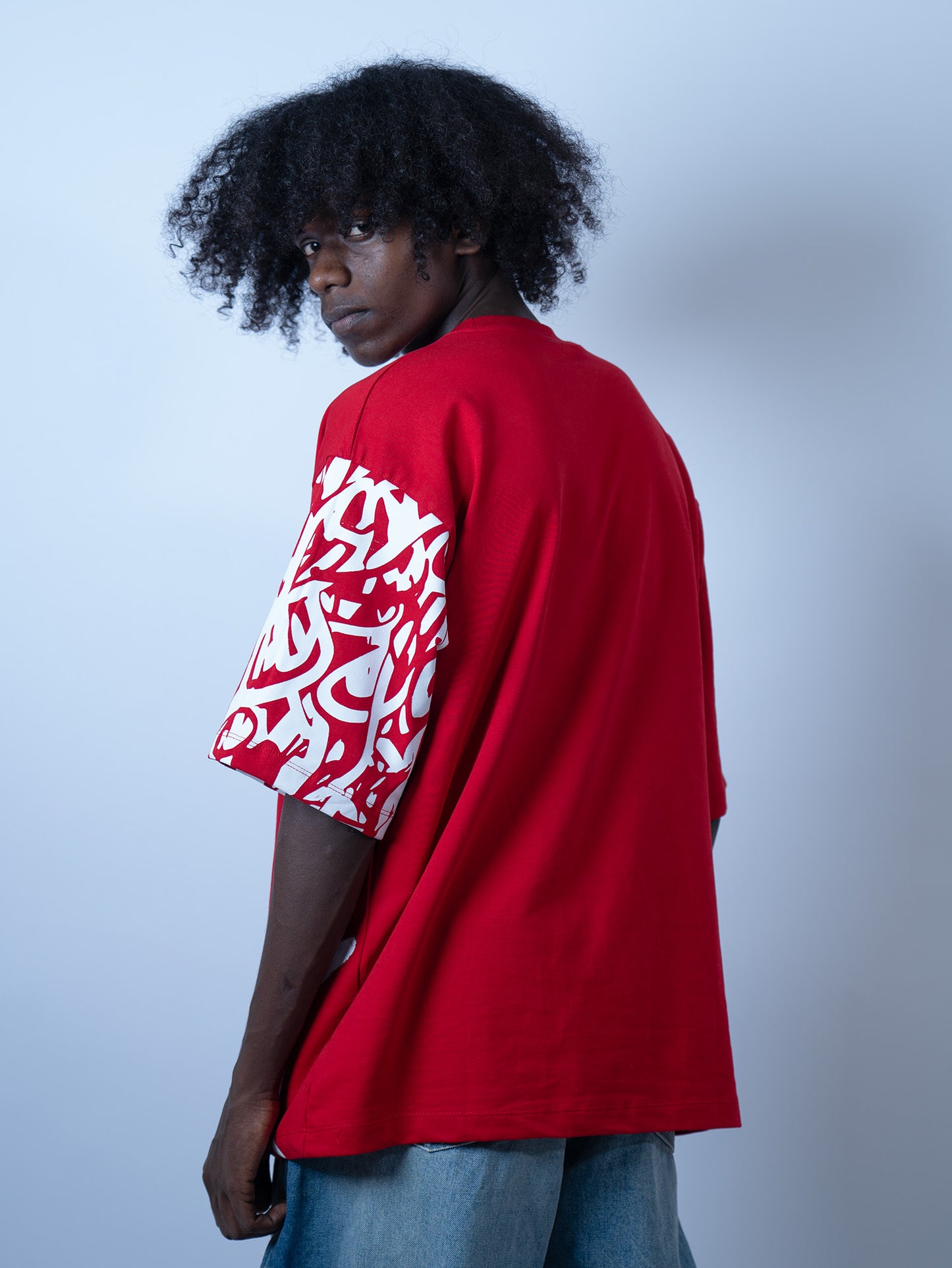 Rear view image of a guy wearing Red graffi tee from Ballucci.