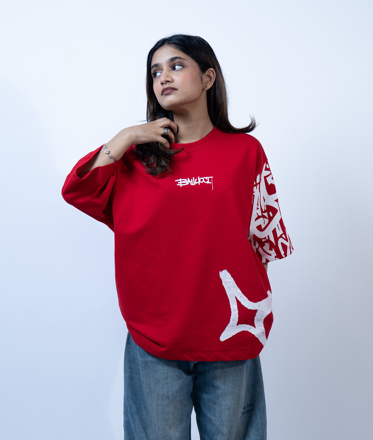 Front view image of a girl wearing red graffi tee from a street wear brand called Ballucci.